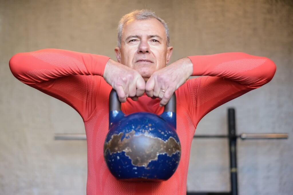 Older man exercising with kettlebell