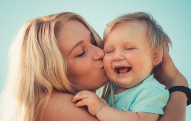 Mother kissing baby