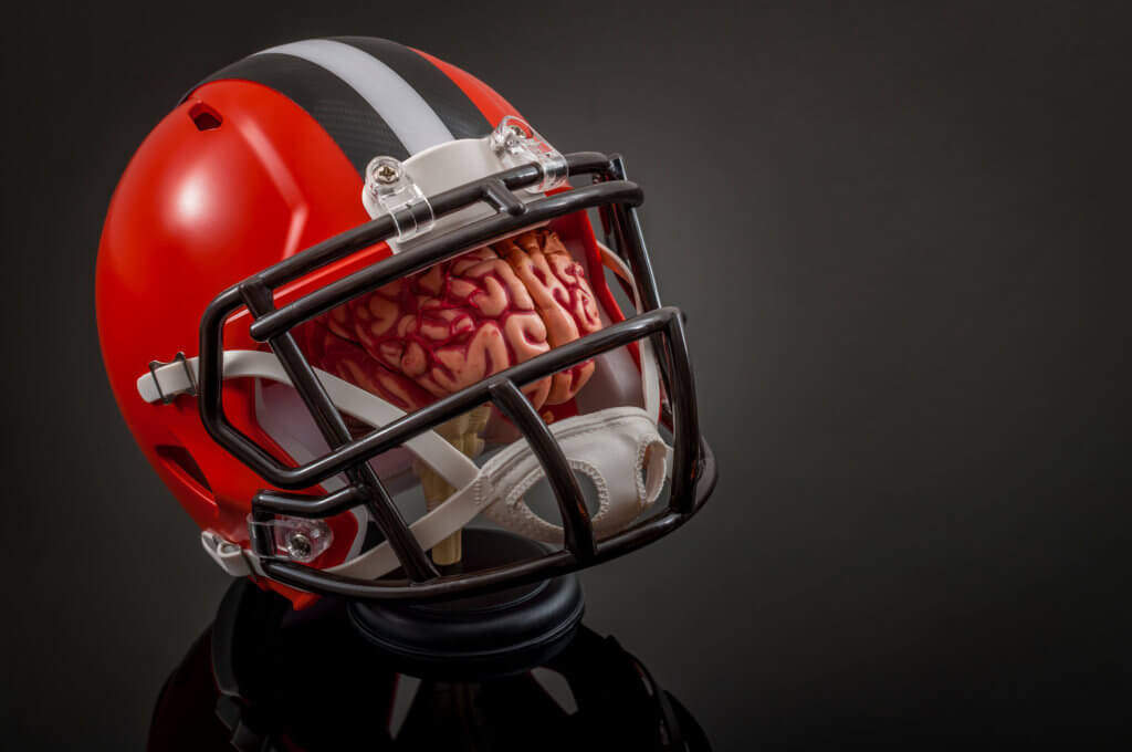 Image of brain wearing a football helmet