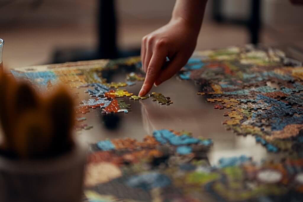 Person doing a jigsaw puzzle