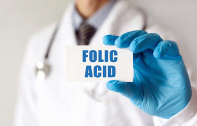 Doctor holding a card with text Folic Acid