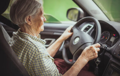 Older woman driving car