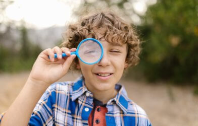 Curious child with magnifying glass