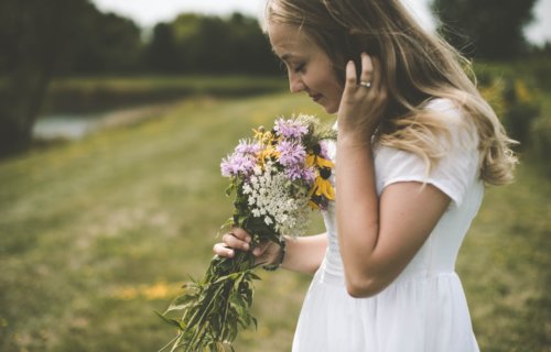 Woman smelling a bouquet of flowers